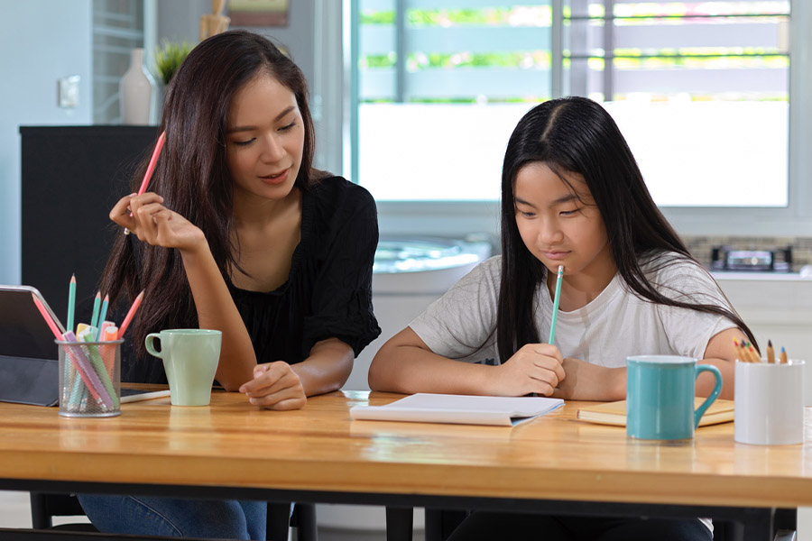 student and tutor together at a desk in Passadena